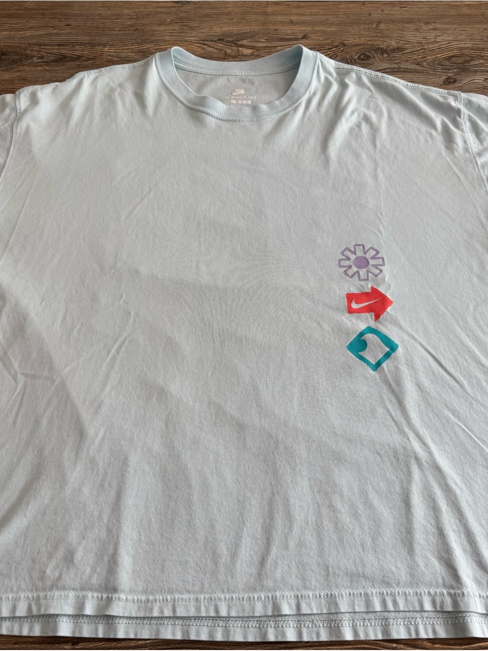 Nike Light Blue Tee with Purple, Red and Teal Icons